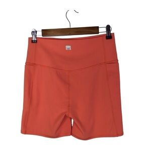 Vuori Studio Pocket Short in Grapefruit.